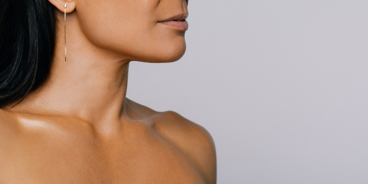 girl looking into the mirror wearing a towel